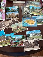 Photo showing a spread of various postcards including a map of St Lucia, windmill, castles, and cities from Ireland, England, and Italy.