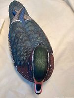 Top view of the Wood Duck drake carving showing detailed painted feathers and realistic colors.