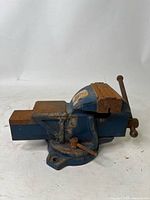 Full view of the bench vise showing the main body, jaws, and base with some surface rust and oxidation visible.