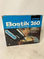 Front side of the original Bostik 260 Electric Glue Gun box showing the product name, brand Emhart, and photo of the glue gun.