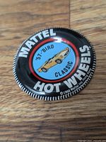 Close-up of the front face of the 1968 Mattel Hot Wheels '57 Bird Classic button badge displaying the car illustration and text.