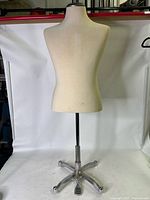 Full front view of fabric-covered torso mannequin mounted on chrome swivel stand with five-leg base on white backdrop.