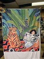 Full view of the wall hanging showing the tiger, woman, and jungle motif.