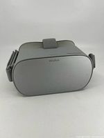 Front view of the Oculus VR headset faceplate showing the gray plastic surface and Oculus logo.