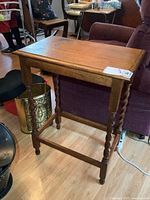 Full view of the solid oak barley twist side table showing definition of the legs and top surface.