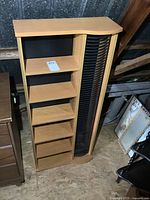 Front side view of the wooden media storage stand showing five shelves and vertical rotating CD/DVD rack on the right side.