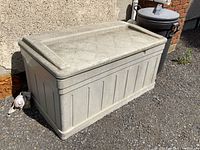 Full front view of Suncast resin deck box showing length and hinge lid.