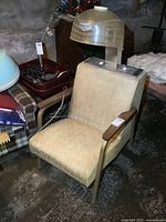 Front angle showing beige chair upholstery, wooden armrests, and transparent hood dryer attached to chair back.