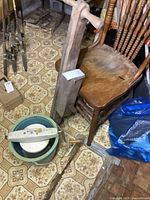 Image showing the vintage wooden corn planter and the ice cream maker bucket with a chair and floor tiles in the background.