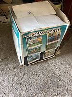 View of the original box packaging for the Le Campa Potti portable toilet, showing branding and general condition of box.