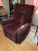 Front left angle view showing overall chair condition and upholstery with remote in seat