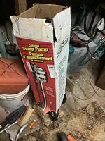 Box of column sump pump showing full product image and branding with red and white colors.