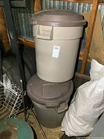 Pair of Rubbermaid Roughneck trash cans stacked, showing overall size and shape.