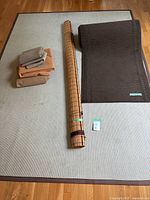 Overview of beige rug, brown runner, wooden blind and stacked underlays