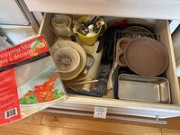 Drawer with assortment of bakeware, pans, flexible chopping mats