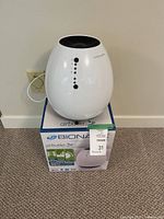 Air purifier resting on original box showing overall appearance