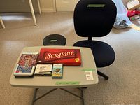 Overall shot of chair, folding table with games displayed