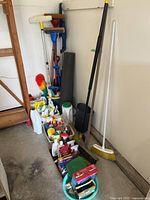 Overall lot showing cleaners in tote, cleaning tools, mat and wastebasket