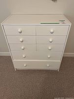 Front view of white six-drawer dresser