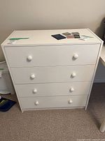 Front and side view of white 4-drawer dresser