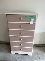 Front view of tall six-drawer dresser