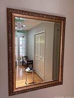 Full view of rectangular mirror hanging on wall