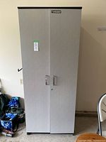 Full view of closed cabinet showing Husky logo, handles, grey finish