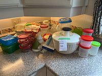 overview of containers, salad spinner, dish rack on countertop