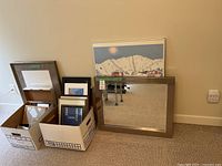 Group shot of mirror, framed art and boxes of frames