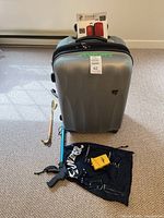 Full lot view showing suitcase, grabber, shoe horn, luggage scale, bag