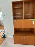 Full view of teak veneer cabinet showing shelving, center door and lower cupboard