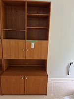 Full view of teak veneer cabinet showing upper shelves, mid doors and lower cupboard