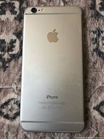 Back view of silver Apple iPhone 6 Plus showing Apple logo and regulatory information.