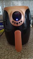 Front view of Copper Chief 2 quart air fryer, showing black and copper design with digital control panel lit up.