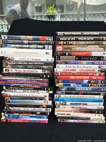 Overview of the 47 DVD movies stacked, showing titles and case condition.