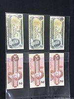 Front side of three Canadian $1 banknotes and three $2 banknotes in protective plastic sleeve.