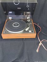 Front view of Pioneer turntable with dust cover open and cables visible