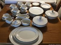 Full set overview showing cups, plates, bowls, platters, gravy boat, covered vegetable bowls, creamer and sugar bowl.