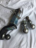 Reese Towpower trailer hitch with three ball mounts, one attached to the hitch, two separate.