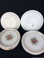 Photo of stacked dinner and lunch plates showing floral and gold detailing as well as plate backs.