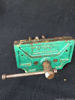 Front view of the vintage metal woodworking vise showing 'P-Z-B Made in England' stamped on the green painted surface.