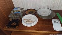 Group view of ashtrays and plates on shelf