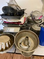 Group view of stacked baking pans on rack and table