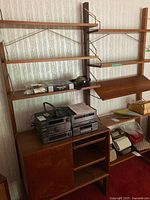 Full view of two-bay teak wall unit with shelves, desk shelf, cabinet and audio equipment on lower section
