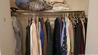 Closet rod with assorted women’s clothing on hangers