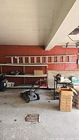 Full view of ladder stored on wall shelf in garage