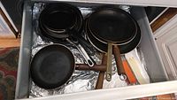 Drawer view showing entire group of frying pans