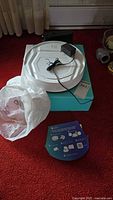 Robot vacuum, charging dock on top, retail box base, plastic bag
