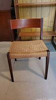 Front view of wood chair with woven seat