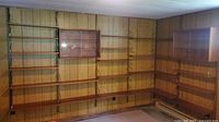 Full wall view of shelving system showing shelves, metal tracks, two glass-front cabinets